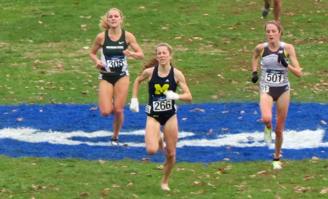 PHOTO: Erin Finn of the University of Michigan (center) sprinting barefoot to a 19th place finish at the 2015 NCAA Division I Cross Country Championships in Louisville, Ky., ahead of Alexis Wiersma of Michigan State and Sarah Collins of Providence College (photo by David Monti for Race Results Weekly)